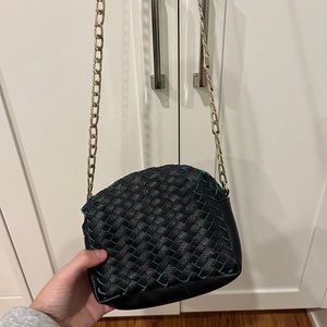 small over-the-shoulder teal and black handbag